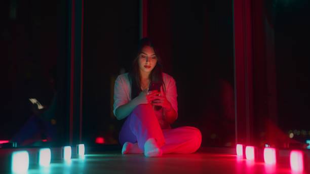 istock Young woman using smart phone at home at night 1449598302