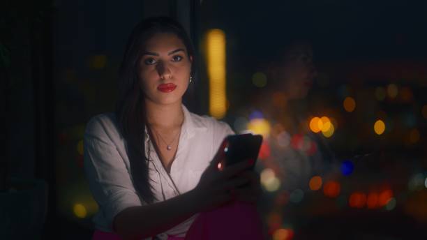 istock Young woman using smart phone at home at night 1449599919