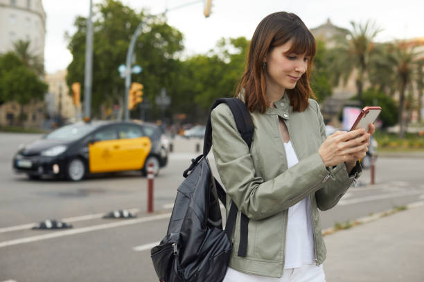 istock Urban multitasker: young woman texting and walking. 1449601794
