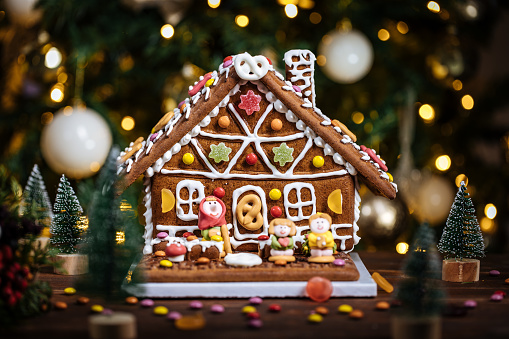 A cozy background of gingerbread houses, decorated with candies