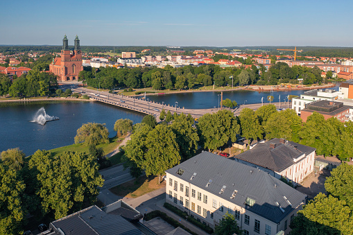 A summer day view over central Eskilstuna, towards the bridge crossing Eskilstunaån river and the iconic Klosters kyrka (church).