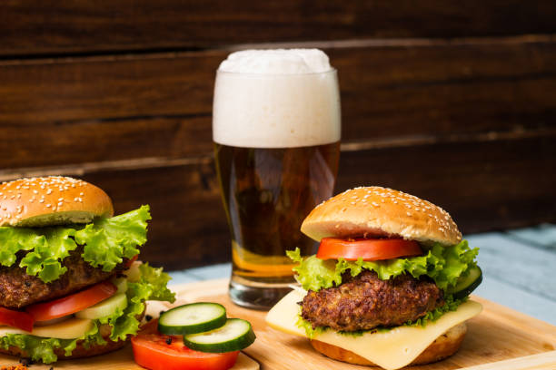 istock Burgers and beer on wooden background 1449603272