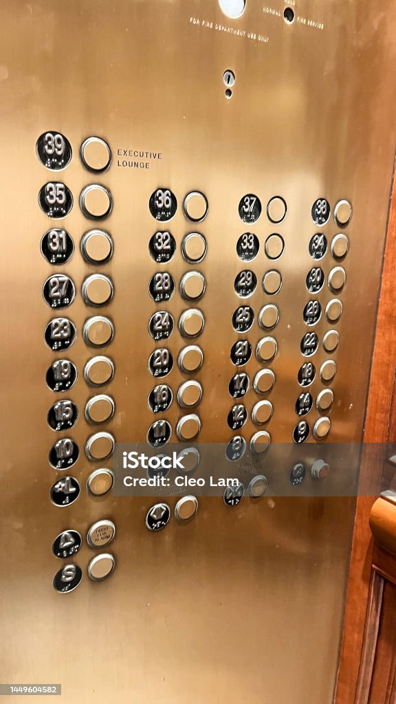 Elevator Buttons in a Traditional Old Style New York Hotel Large number of floors in gold background tradition elevator lift in a New York City hotel Elevator Stock Photo
