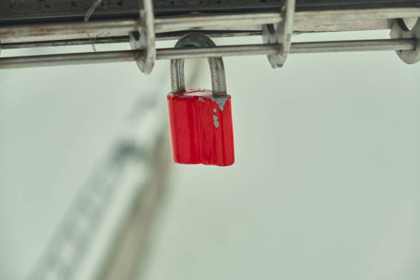 istock Frozen padlocks are installed along the bridge path and the love locks are thrown into the river with the hope of loving bonds continue to be non-releasable Natural light selective focus 1449604855