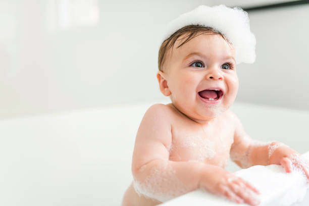 istock Baby boy bathes in a bath with foam and soap bubbles 1449605385