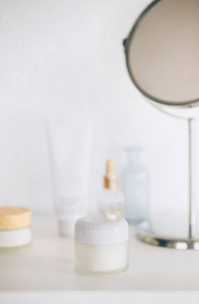 istock Cosmetic products and mirror on table 1449612470