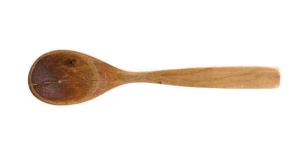 Old worn wooden spoon with clipping path Isolated worn wooden spoon isolated with clipping path wooden spoon stock pictures, royalty-free photos & images