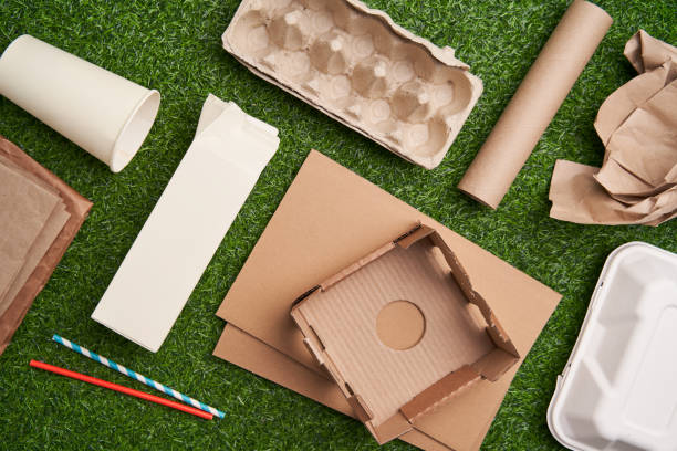 istock Paper collected for recycling on green grass background. 1449616094