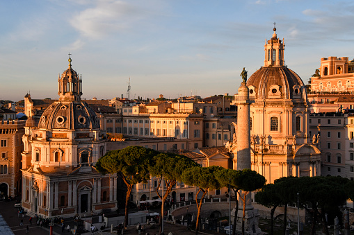 Panorama taken from the panoramic terrace of the Altare della Patria. At sunset, the golden rays of the sun illuminate the monuments of ancient Rome.