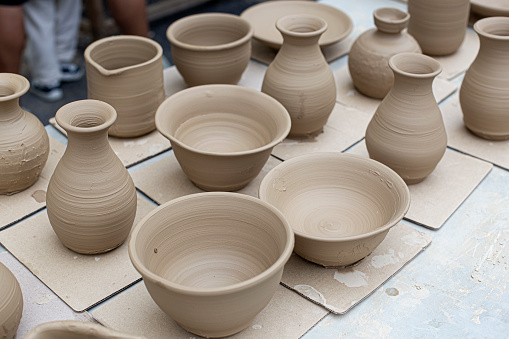 raw ceramic bowls made from white clay waiting for putting in the pottery kiln.