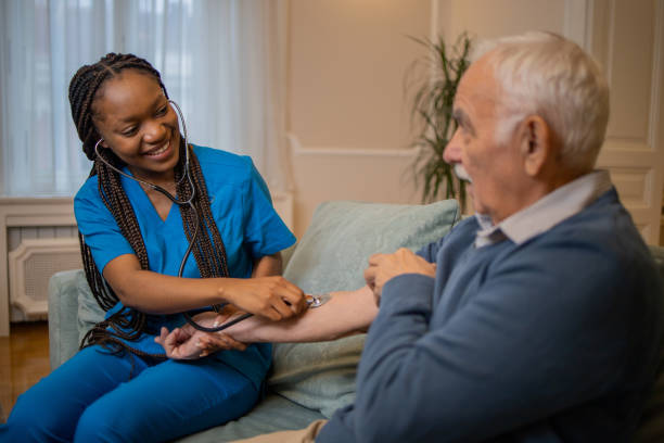 istock Retired man with female home carer 1449617992