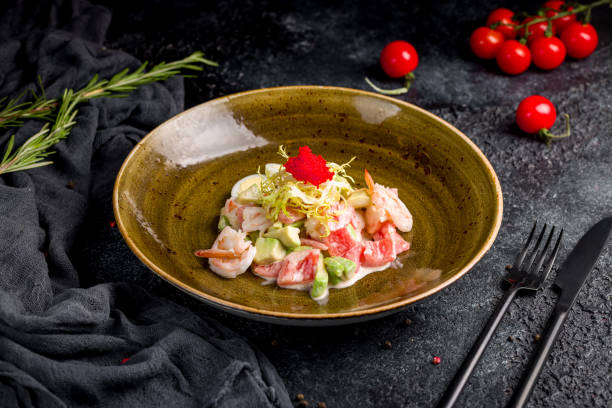 istock salad with shrimp, avocado and tomatoes on black table 1449618065
