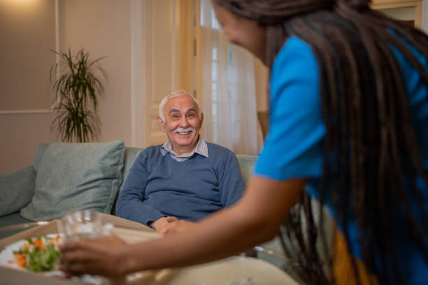 istock Nurse helping senior man 1449618107