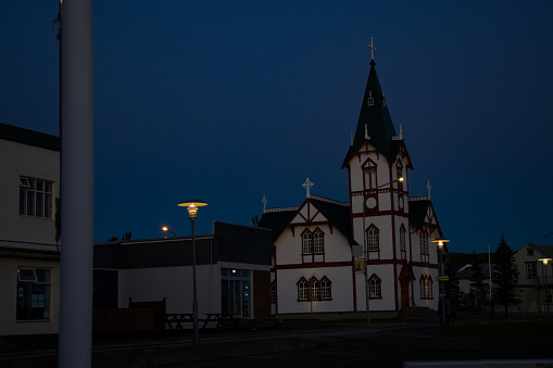 Evening Sunset view from fishing town village in Husavik, Iceland Church overlooking Atlantic Ocean