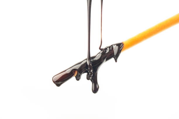 istock The chocolate sauce flows over the biscuit stick 1449623215