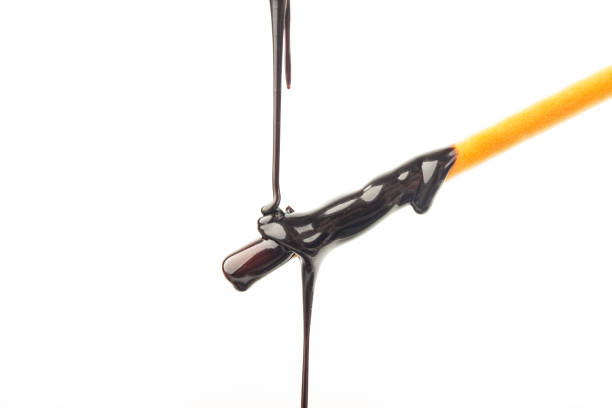 istock The chocolate sauce flows over the biscuit stick 1449623216