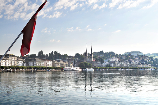 Sunny morning at the city of Lucerne, Switzerland, with a clear reflection of the buildings at the Reuss River