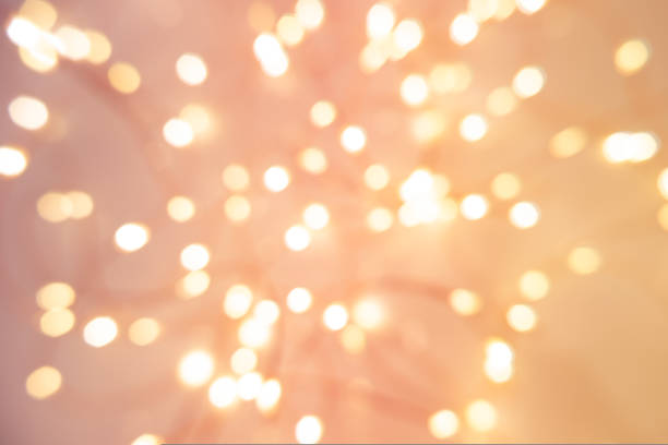 istock Defocused abstract Christmas background with garland pink light 1449624222