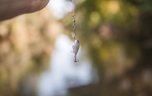 An unrecognizable man spends the day enjoying his favorite hobby, fishing