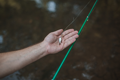 An unrecognizable man spends the day enjoying his favorite hobby, fishing