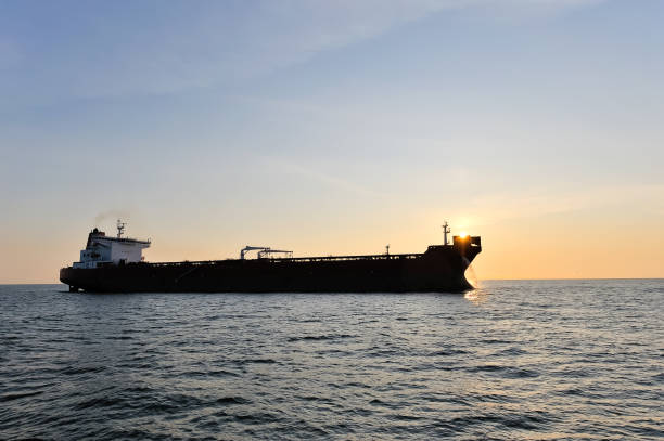 Crude oil tanker in the sea at sunset. Crude oil tanker in the sea at sunset. oil tanker stock pictures, royalty-free photos & images