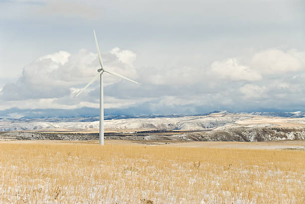 Wind Power Generator in a snow swept field.  Photographed on a cold, blustery winter day.
