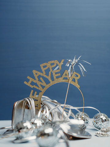New years and glitter still life photo party accessories\nStill life studio shot on blue background