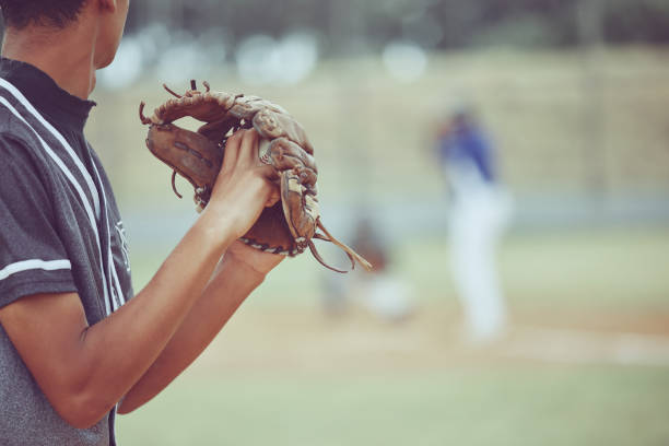 istock Baseball, sports and a pitcher throwing a ball during a competitive game or match on a grass pitch field. Fitness, exercise and sport with a man baseball player playing in a competitive outdoor event 1449631728