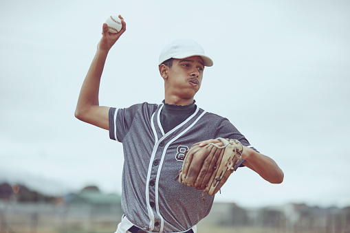 Baseball, baseball player and ball throw in baseball field in match, training game or competition. Sports, fitness and baseball pitcher man from India practice pitch outdoors for exercise or workout.