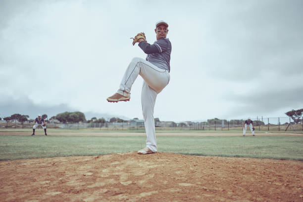 istock Baseball pitch, athlete and man from Guatemala ready to throw for exercise, training and game workout. Team fitness, baseball player and sports with teamwork together on a outdoor dirt field 1449631775