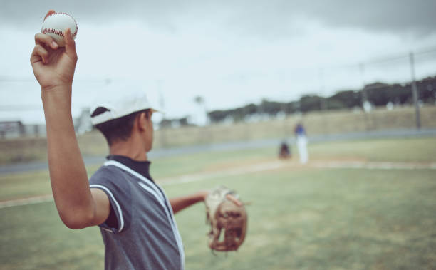 istock Baseball, pitcher and athlete throwing a ball on an outdoor field during a game or training. Fitness, sports and softball player practicing his skill at match or exercise on outside pitch or stadium. 1449631789