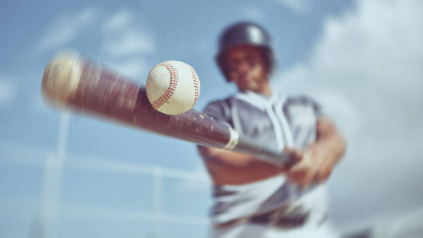 Baseball, baseball player and bat ball swing at a baseball field during training, fitness and game practice. Softball, swinging and power hit with athletic guy focus on speed, performance and pitch stock photo