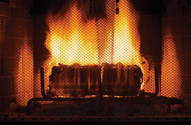 A roaring fire behind a mesh cinder guard. This photo was processed in the CMYK color space to ensure maximum color accuracy when used for print media. It was then converted to RGB to minimize file size. Enjoy!