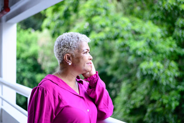 A middle-aged woman looking away to the trees
