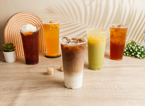 Assorted iced tea Coffee Milk, Green Tea Polyphenols, Ice Cream Black Tea, Ancient Winter Melon, Pineapple served in disposable glass top view of taiwan drink