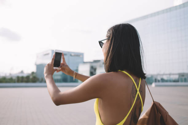 istock Traveling female taking selfie on smartphone 1449638424
