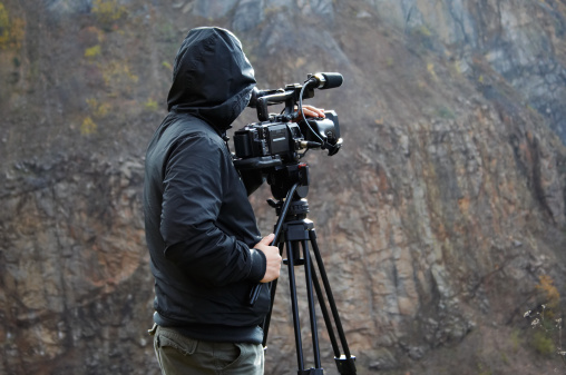 Nature photographer with digital camcorder.