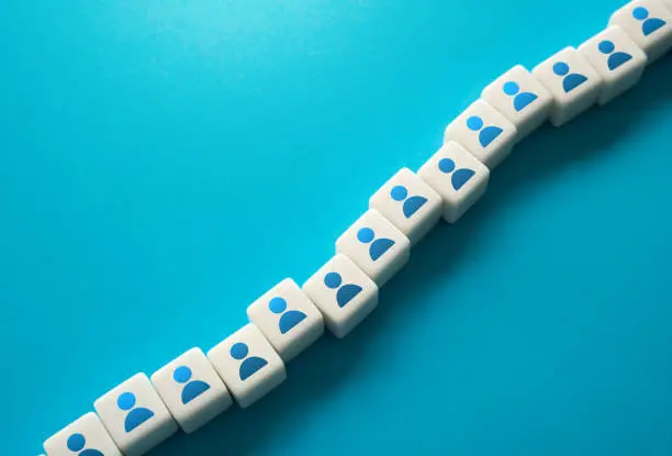 Photo of A chain of blocks with symbols of people.