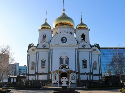 Military Cathedral of the Holy Blessed Prince Alexander Nevsky view from the main facade, a beautiful Orthodox church with golden domes and a strict Celtic cross in front of the entrance