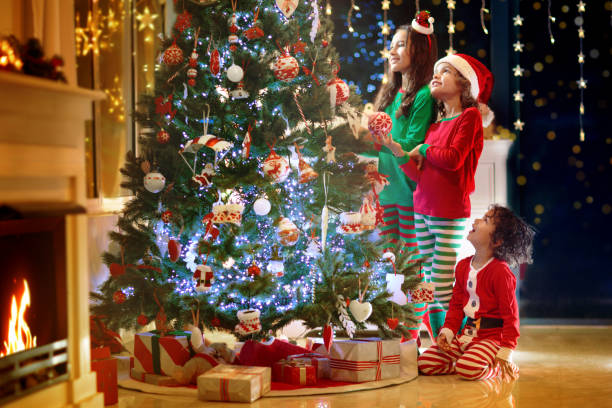 istock Child at Christmas tree. Kids at fireplace on Xmas 1449647435