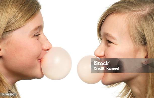 Two Teenage Grils With Chewing Gum Bubbles Stock Photo - Download Image Now - Adult, Beautiful People, Beauty