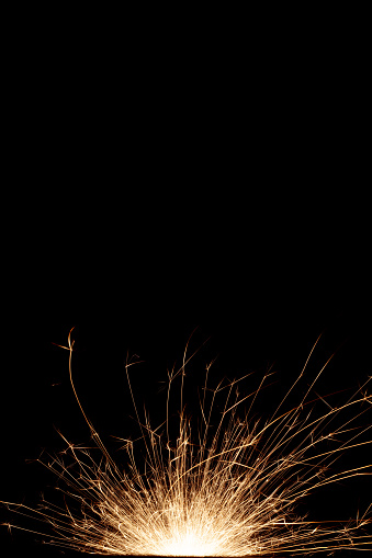 Lines of light from flying sparks in the dark