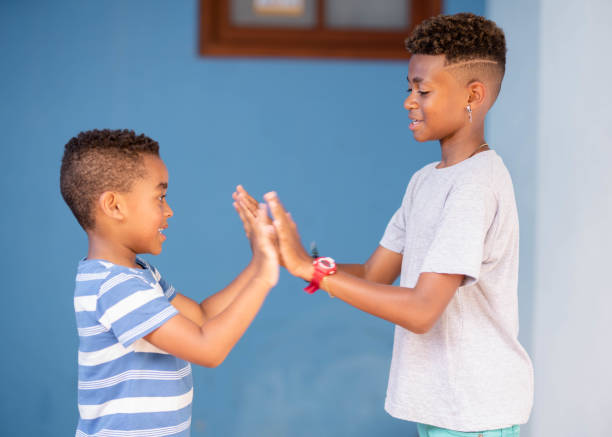 istock Two smiling young brothers playing together on their patio 1449654460
