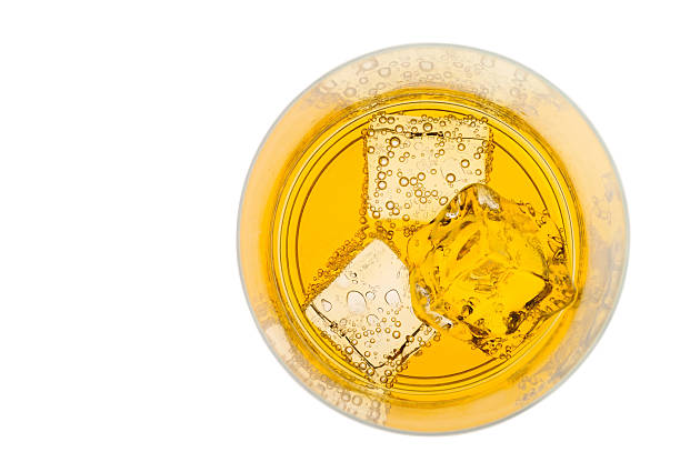 istock Glass of yellow drink with ice from top 144965478