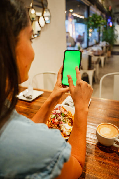 istock A Women Checking her Phone in a Cafe 1449658066