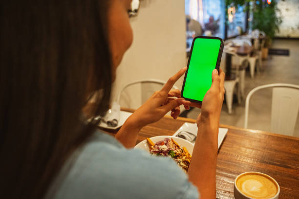 istock A Women Checking her Phone in a Cafe 1449658595