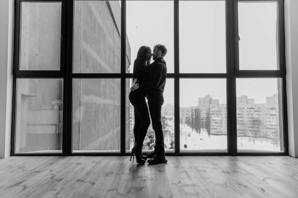 istock Smiling and lovely multiethnic couple tenderly hug on balcony 1449659342