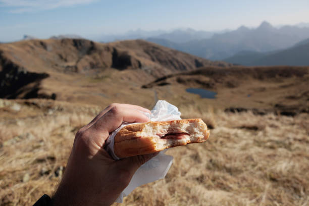 istock eating a sandwich on top of a mountain 1449659847