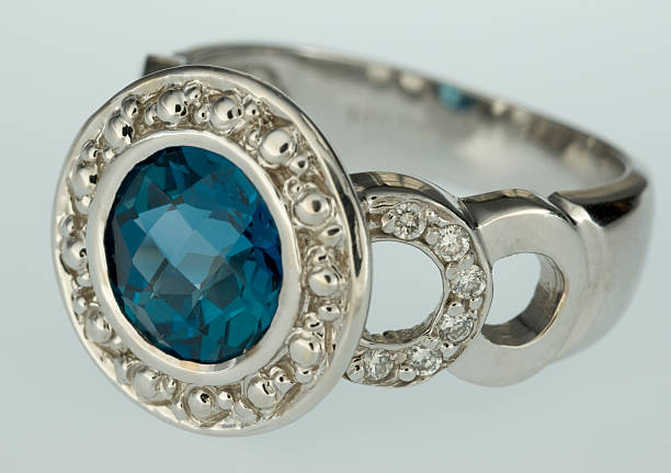 istock woman's gold ring with topaz and diamonds 144966157