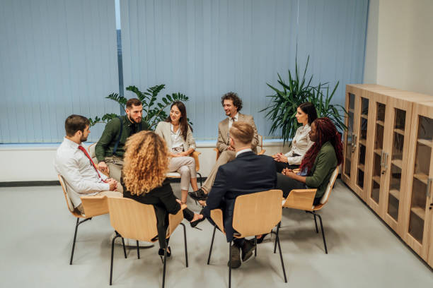 istock Business team sitting in circle and discussing 1449663216